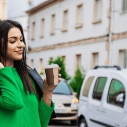 Woman shopping with bags and coffee to go
