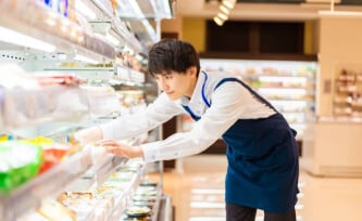 Grocery store employee stocking shelves.