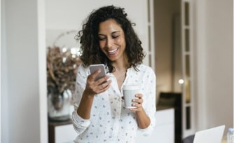 Woman reviewing her checking account online from her mobile device.