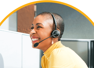 woman in yellow shirt smiling and wearing headset