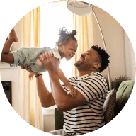 Father playfully swings daughter in the air after opening a CD account.