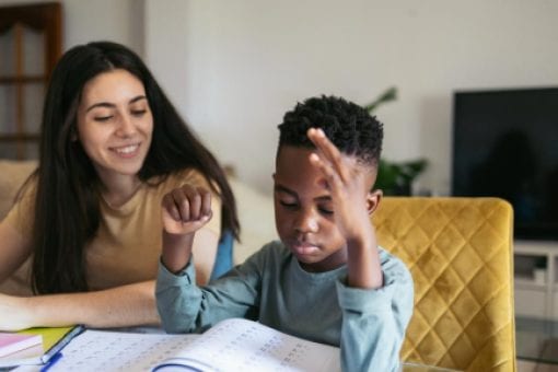 A college student looks to her young student as she tutors him in math.